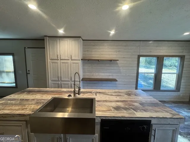 a kitchen with granite countertop a stove and a refrigerator