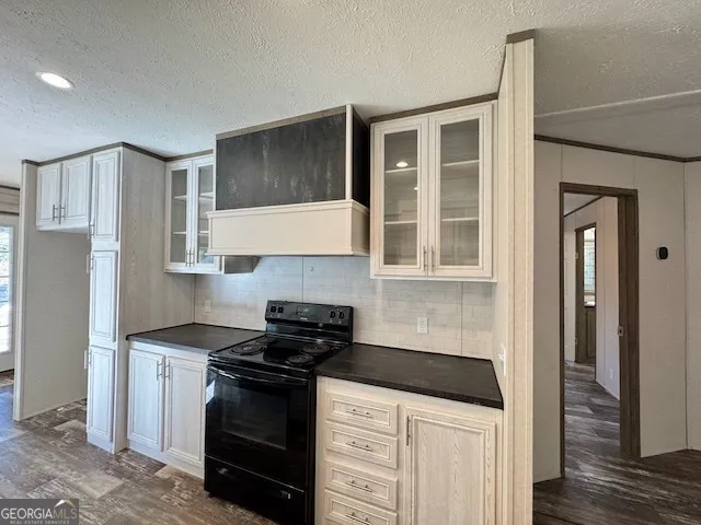 a view of kitchen with sink and refrigerator