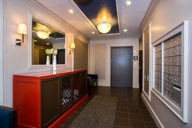 a view of a hallway with wooden floor and door