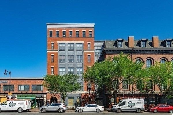 a front view of a building with parking space
