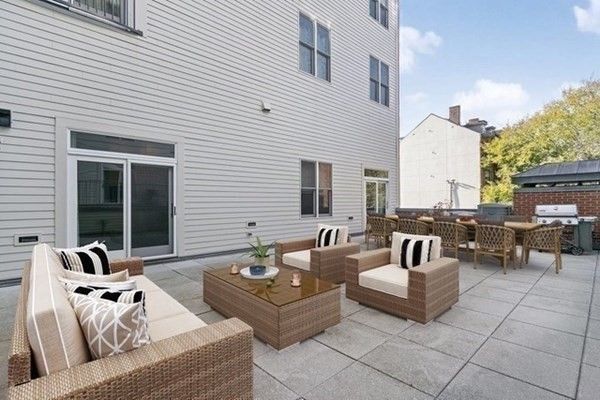 a view of a patio with couches and a potted plant on the table