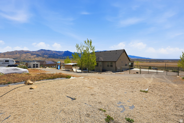 1588 West Rim Rock Drive Stockton, UT 84071 - Photo 42 of 61 Expansive gravel lot with mountainous backdrop and distant plains