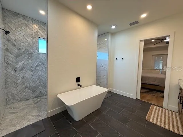 a bathroom with a bathtub and shower