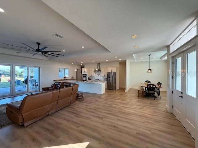 a living room with furniture and a wooden floor