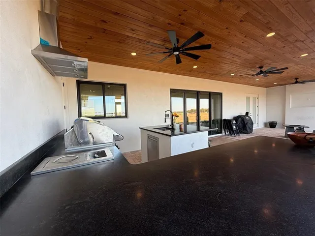 a view of a livingroom with wooden floor and a sink