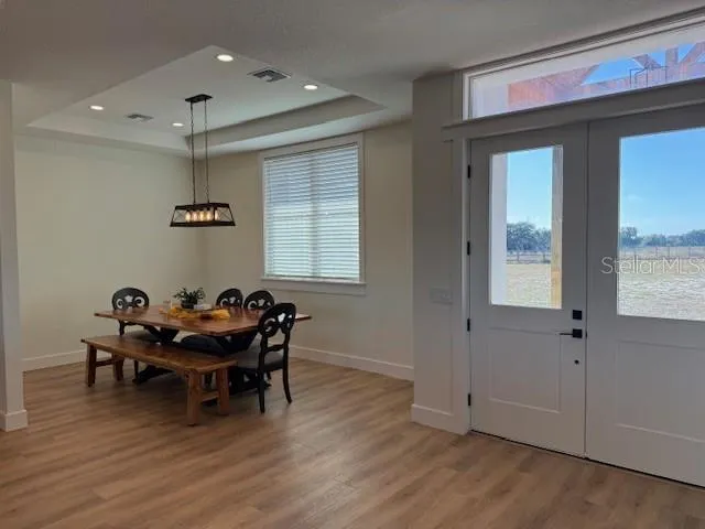 a kitchen with stainless steel appliances a refrigerator sink and wooden floor