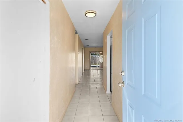 a view of a hallway with a dining area