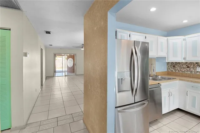 a kitchen with stainless steel appliances a refrigerator sink and cabinets