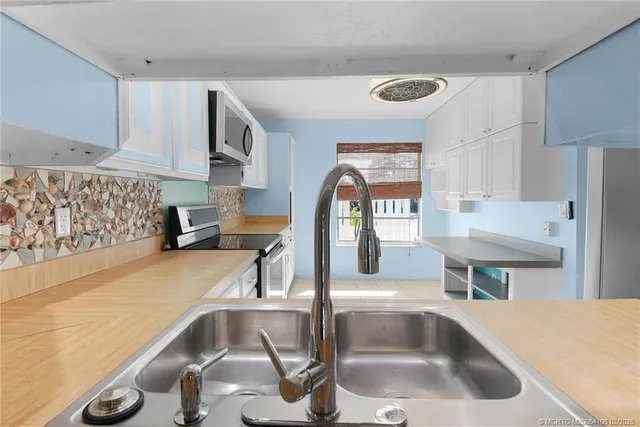 a kitchen with a sink a counter top space and appliances