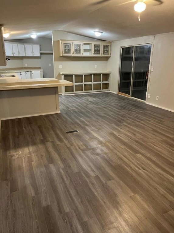 229 North 2nd Street Walnut Springs, TX 76690 - Photo 3 of 6 a living room with a wooden floor and kitchen view