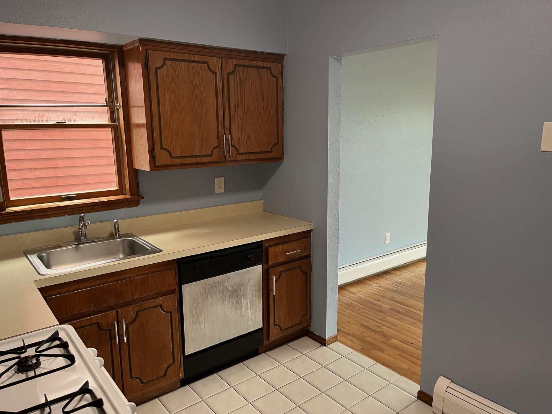 577 Piermont Avenue, Unit A1 Piermont, NY 10968 - Photo 3 of 6 Kitchen with dishwasher, a baseboard radiator, light countertops, and light tile patterned floors