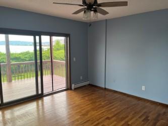 577 Piermont Avenue, Unit A1 Piermont, NY 10968 - Photo 6 of 6 Spare room with a water view, wood finished floors, a ceiling fan, and a baseboard radiator