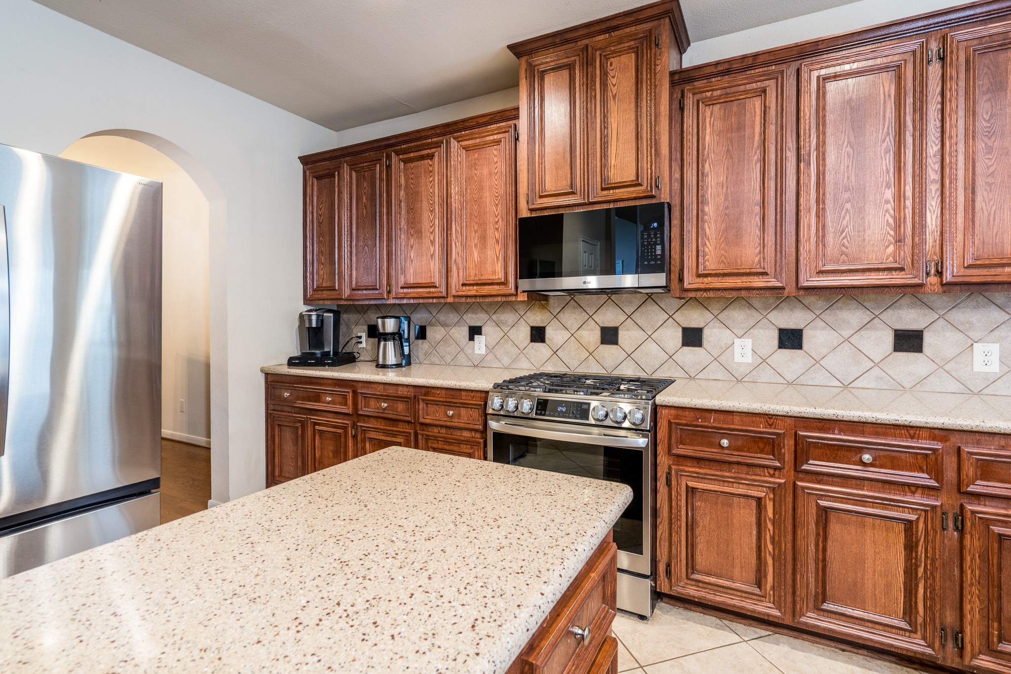 907 Colorado Springs Court Spring, TX 77373 - Photo 8 of 34 Kitchen appliances have been upgraded including range (2024), dishwasher (2023), and microwave (2026).