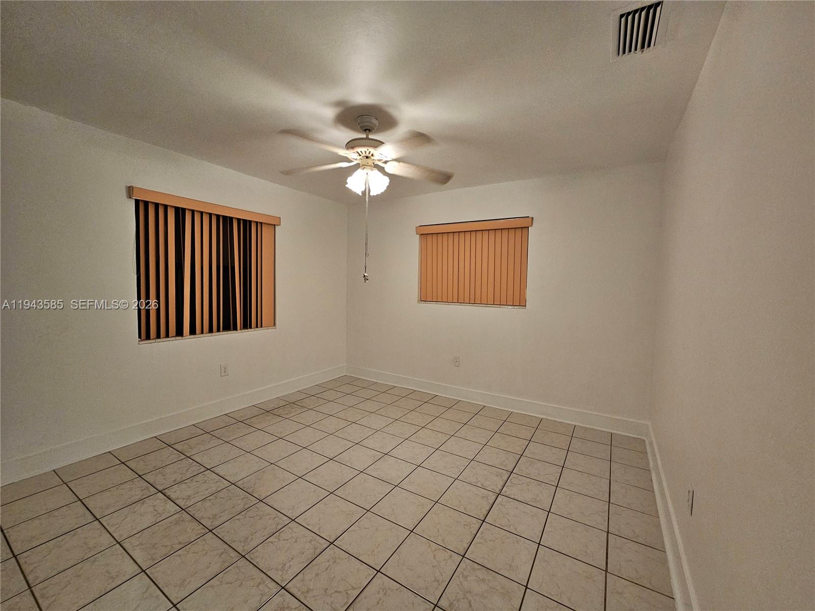 9940 Southwest 162nd Street Miami, FL 33157 - Photo 8 of 21 an empty room with windows and fan