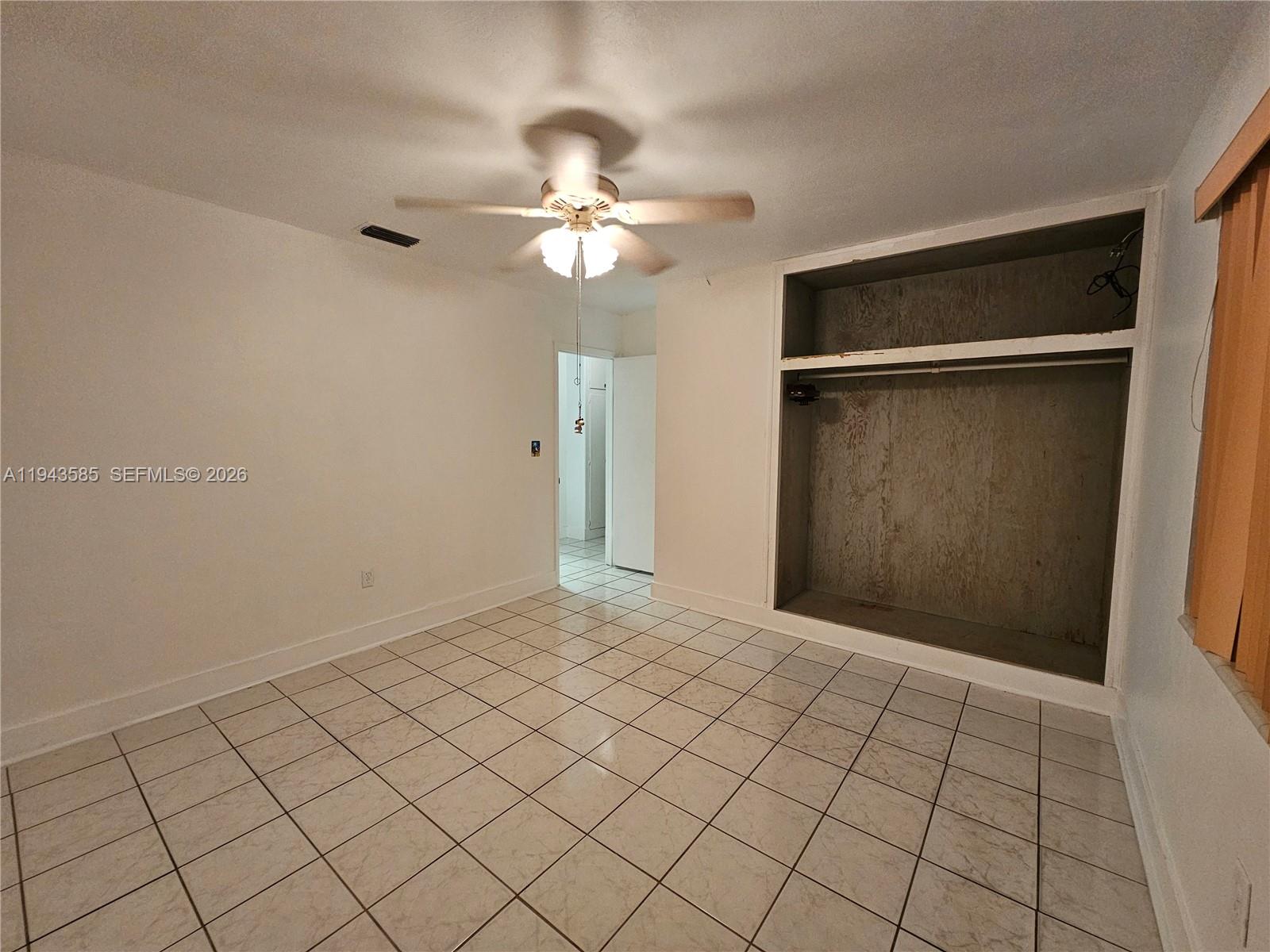 9940 Southwest 162nd Street Miami, FL 33157 - Photo 9 of 21 a view of an empty room and chandelier fan