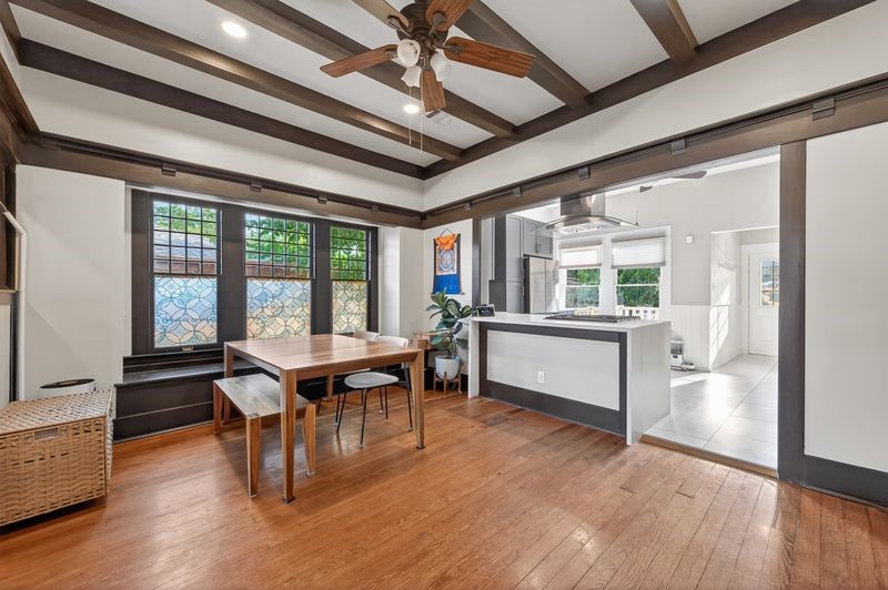 1414 Finch Street Houston, TX 77009 - Photo 6 of 24 The dining area flows seamlessly into the fully renovated kitchen, blending historic charm with modern comfort. The oversized island with cooktop creates the perfect gathering space while overlooking the dining room, making entertaining effortless. Designed with versatility and functionality in mind, the kitchen offers abundant storage, updated finishes, and a layout ideal for everyday living.