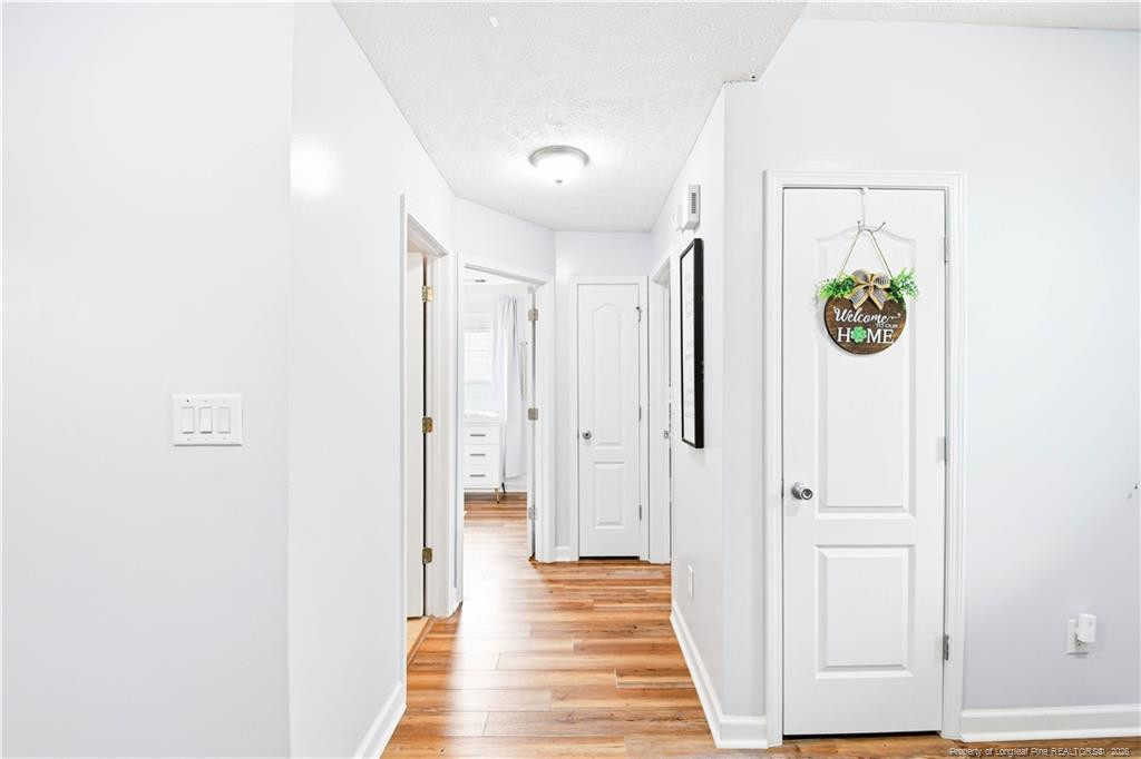 212 Lennox Loop Raeford, NC 28376 - Photo 17 of 47 a view of a hallway with wooden floor