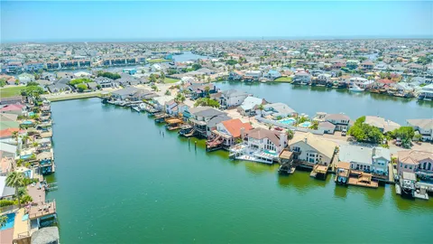 an aerial view of a houses with a lake view