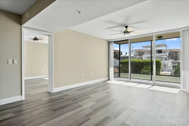 a view of room with wooden floor and ceiling fan