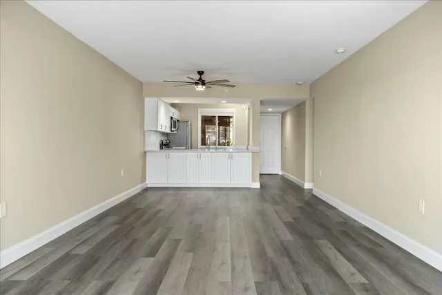 a view of a kitchen with wooden floor and window