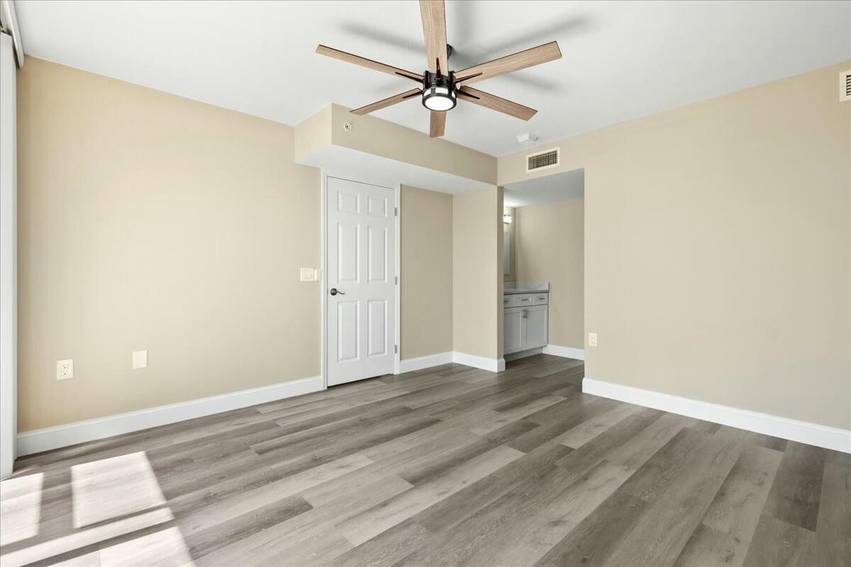 2601 Marina Isle Way, Unit 103 Jupiter, FL 33477 - Photo 21 of 56 wooden floor in an empty room