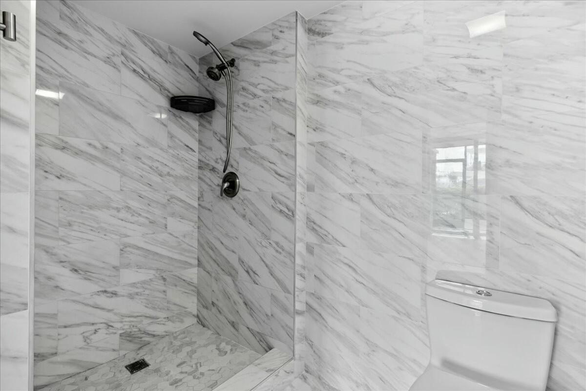 2601 Marina Isle Way, Unit 103 Jupiter, FL 33477 - Photo 25 of 56 a bathroom with a shower