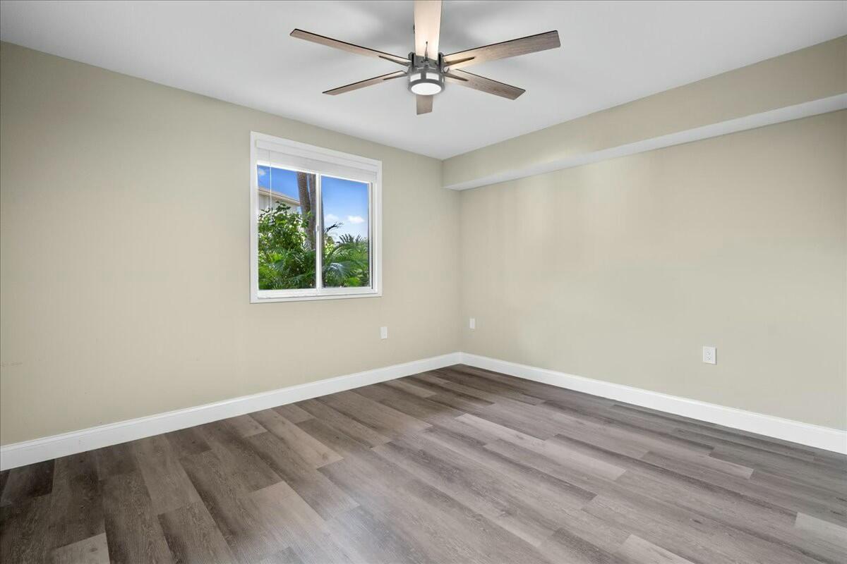 2601 Marina Isle Way, Unit 103 Jupiter, FL 33477 - Photo 29 of 56 an empty room with a window and a fan
