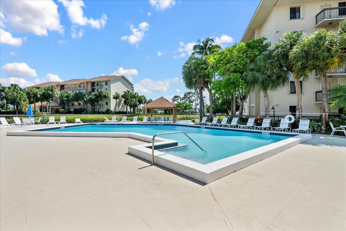 2601 Marina Isle Way, Unit 103 Jupiter, FL 33477 - Photo 32 of 56 a view of outdoor space with swimming pool and seating