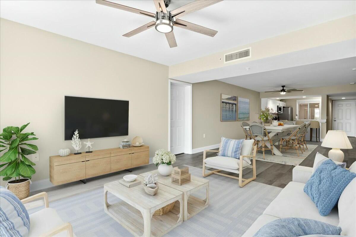 2601 Marina Isle Way, Unit 103 Jupiter, FL 33477 - Photo 7 of 56 a living room with furniture and a flat screen tv