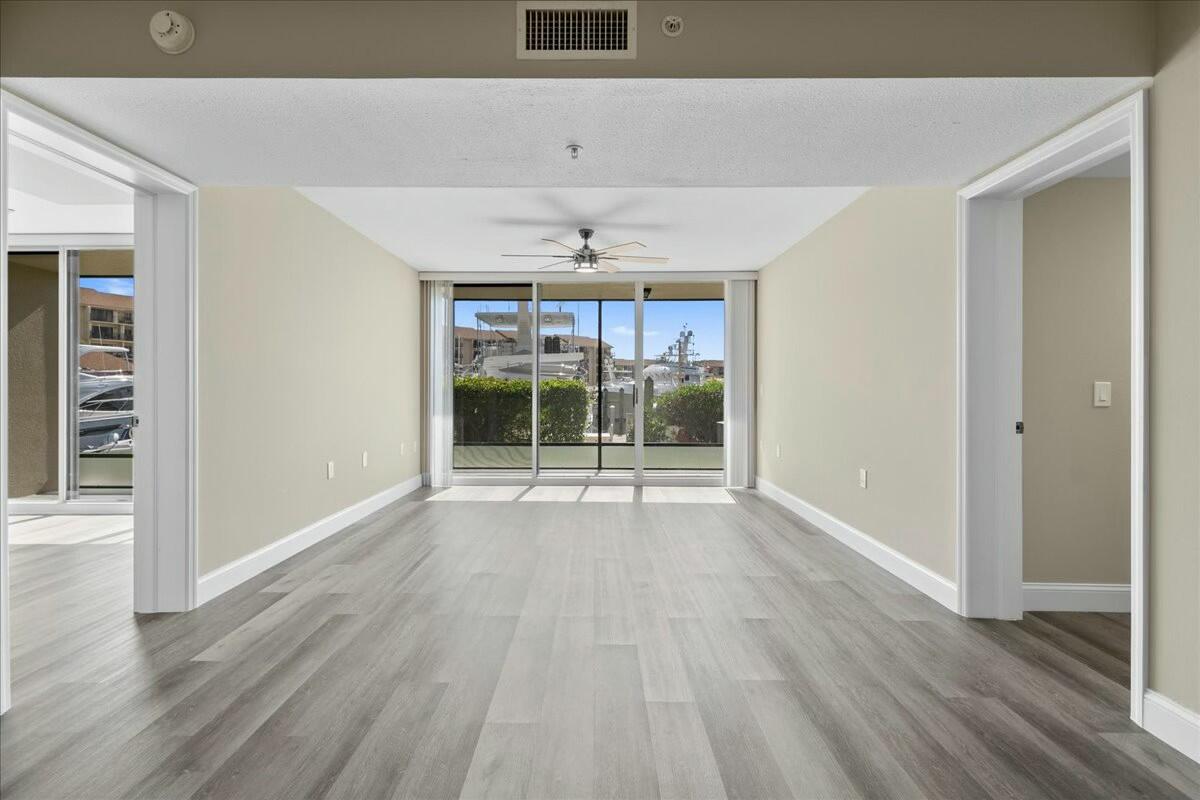 2601 Marina Isle Way, Unit 103 Jupiter, FL 33477 - Photo 9 of 56 wooden floor in an empty room with a window