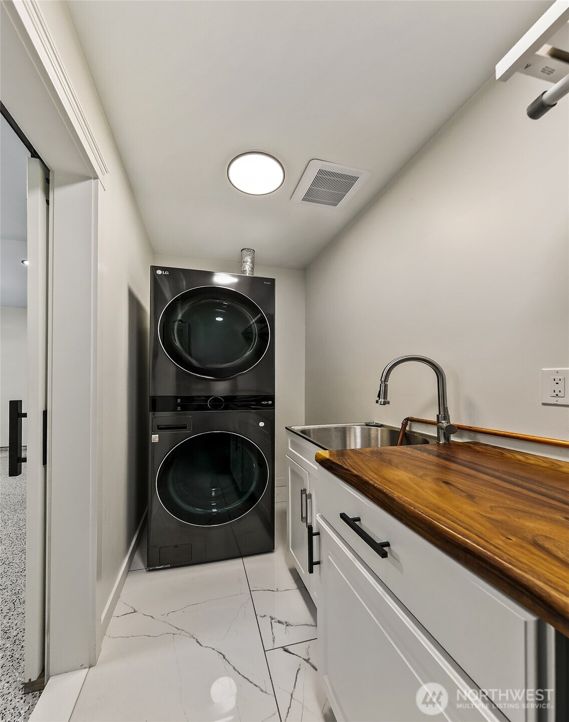 23115 15th Avenue Southeast, Unit D1 Bothell, WA 98021 - Photo 21 of 24 a close view of a sink and a washer and dryer