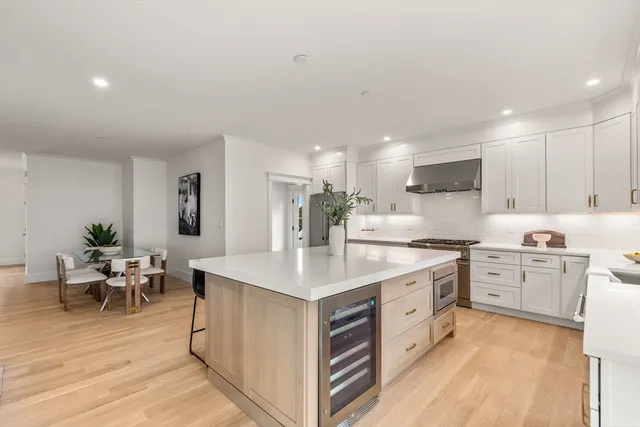 a large white kitchen with cabinets
