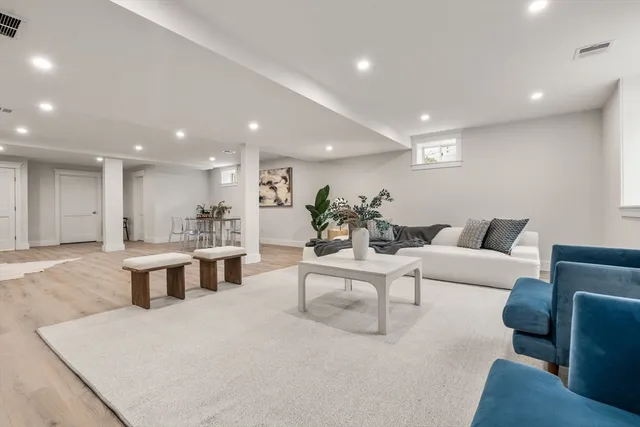 a living room with furniture a wooden floor