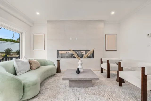 a living room with furniture and white walls