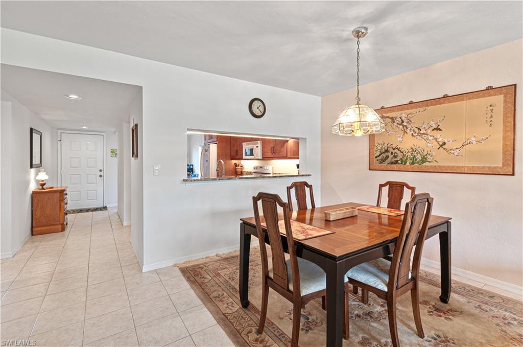 1208 Commonwealth Circle, Unit J103 Naples, FL 34116 - Photo 11 of 31 a dining room with furniture and window