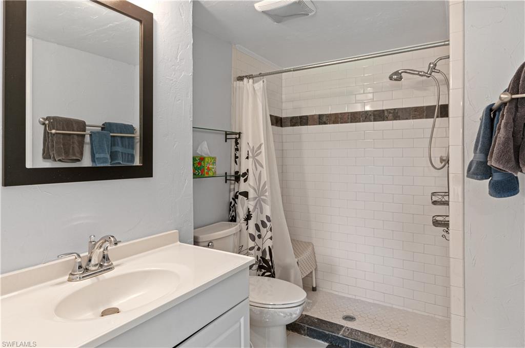 1208 Commonwealth Circle, Unit J103 Naples, FL 34116 - Photo 18 of 31 a bathroom with a sink toilet and shower