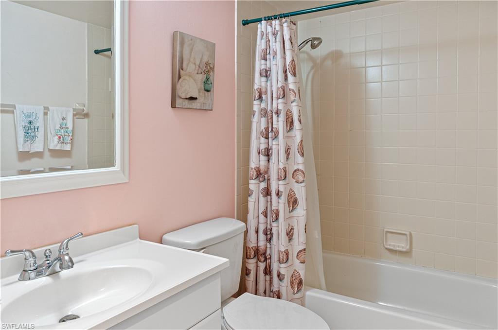1208 Commonwealth Circle, Unit J103 Naples, FL 34116 - Photo 20 of 31 a bathroom with a sink toilet and shower