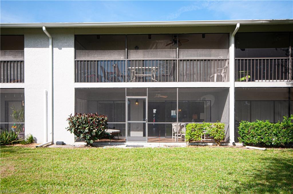 1208 Commonwealth Circle, Unit J103 Naples, FL 34116 - Photo 25 of 31 a view of a house with a yard and a large window