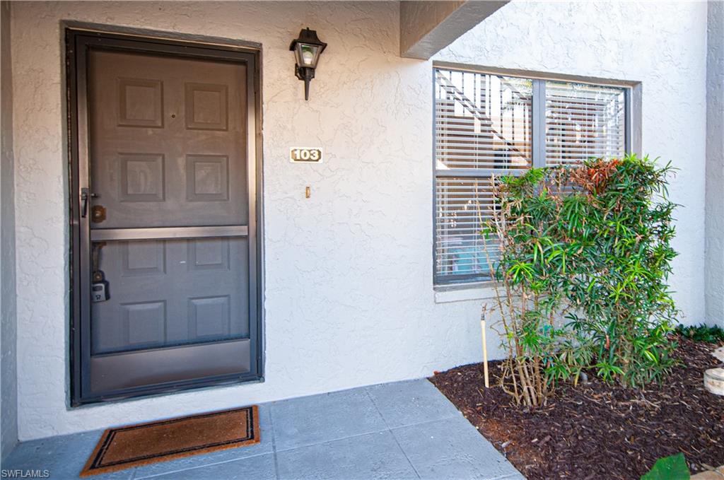 1208 Commonwealth Circle, Unit J103 Naples, FL 34116 - Photo 4 of 33 Property entrance featuring stucco siding