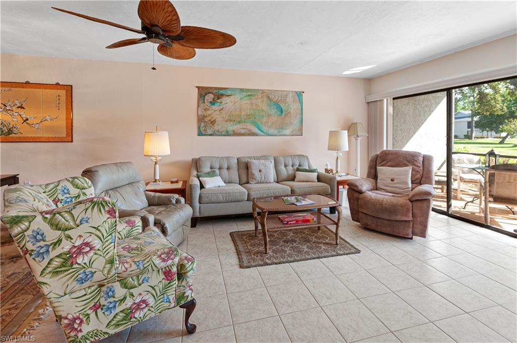 1208 Commonwealth Circle, Unit J103 Naples, FL 34116 - Photo 6 of 31 a living room with furniture and a large window