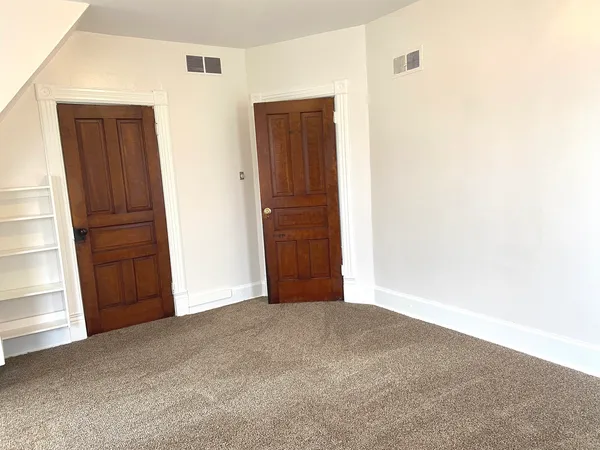 a view of an empty room with closet