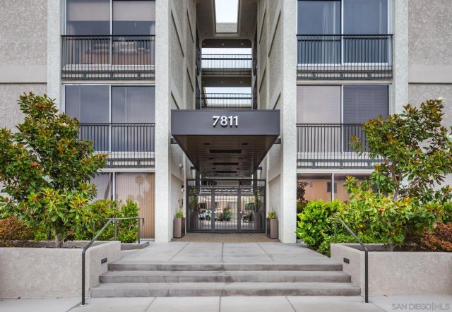 a front view of a building with potted plants