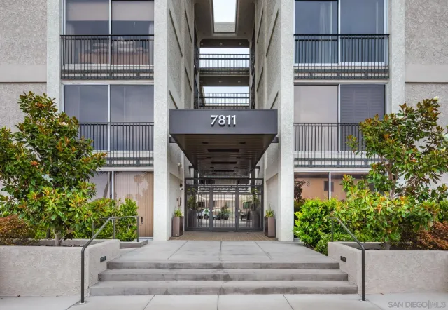 a front view of a building with potted plants