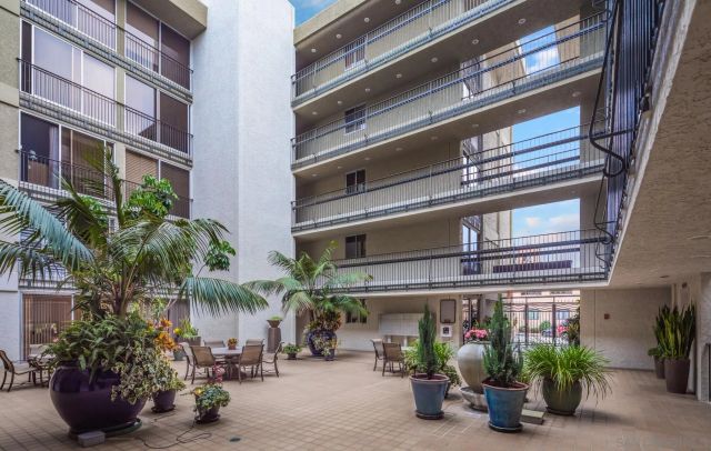 a front view of a building with potted plants
