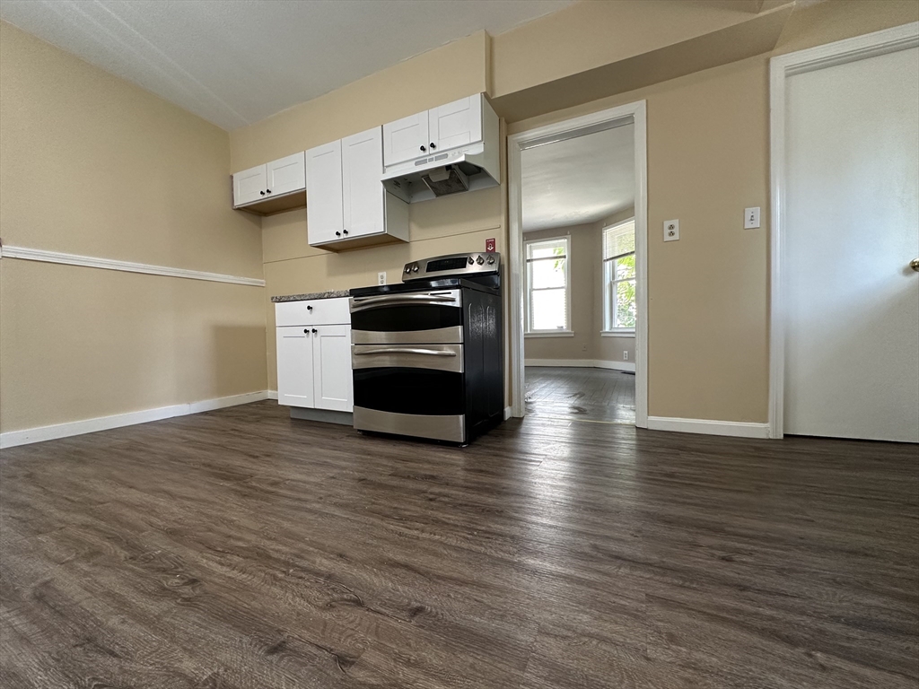 177 Johnson Street Springfield, MA 01108 - Photo 11 of 23 a kitchen with stainless steel appliances a refrigerator and a stove top oven
