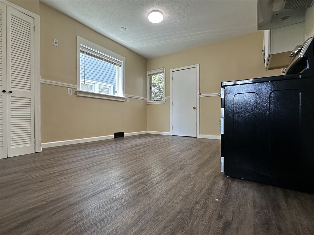 177 Johnson Street Springfield, MA 01108 - Photo 12 of 23 a view of empty room with wooden floor and fan