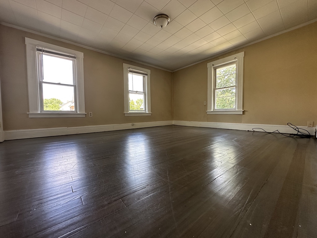 177 Johnson Street Springfield, MA 01108 - Photo 15 of 23 a view of an empty room with wooden floor and a window