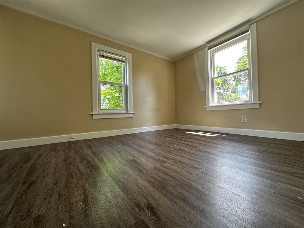 177 Johnson Street Springfield, MA 01108 - Photo 16 of 23 a view of an empty room with wooden floor and a window