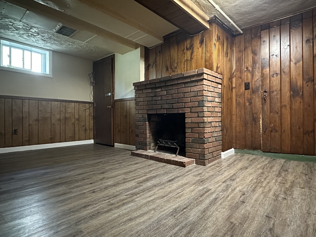177 Johnson Street Springfield, MA 01108 - Photo 18 of 23 a view of an empty room with wooden floor and a fireplace