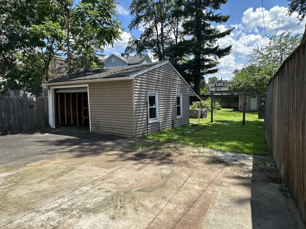 177 Johnson Street Springfield, MA 01108 - Photo 22 of 23 a view of a house with yard and a large tree